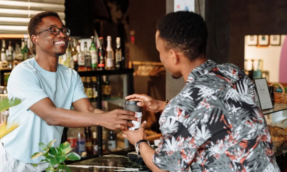 A loyal customer receiving coffee, showing brand loyalty