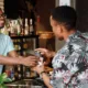 A loyal customer receiving coffee, showing brand loyalty